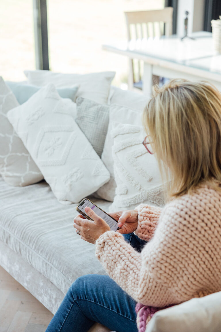 Becky on sofa looking at her phone
